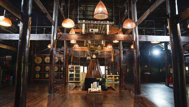 A spacious room with high ceilings, exposed wooden beams, and hanging pendant lights. - MEDDOM Park (Thung Nai)