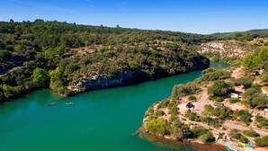 A river surrounded by forested hills with boats on the water. - Mobilhome Gorges de Verdon (Provence-Alpes-Côte d'Azur)