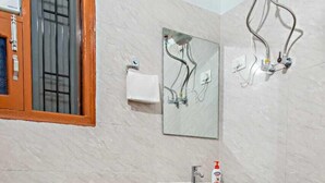 A bathroom with a toilet, a pedestal sink, and a mirror. - THE KASAULI TRAIL (Kasauli)
