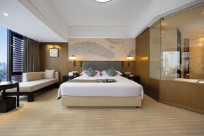 A hotel room with a large bed, a sofa, a desk, and a view of the city. - hunanyueyangHotel (Yueyang)