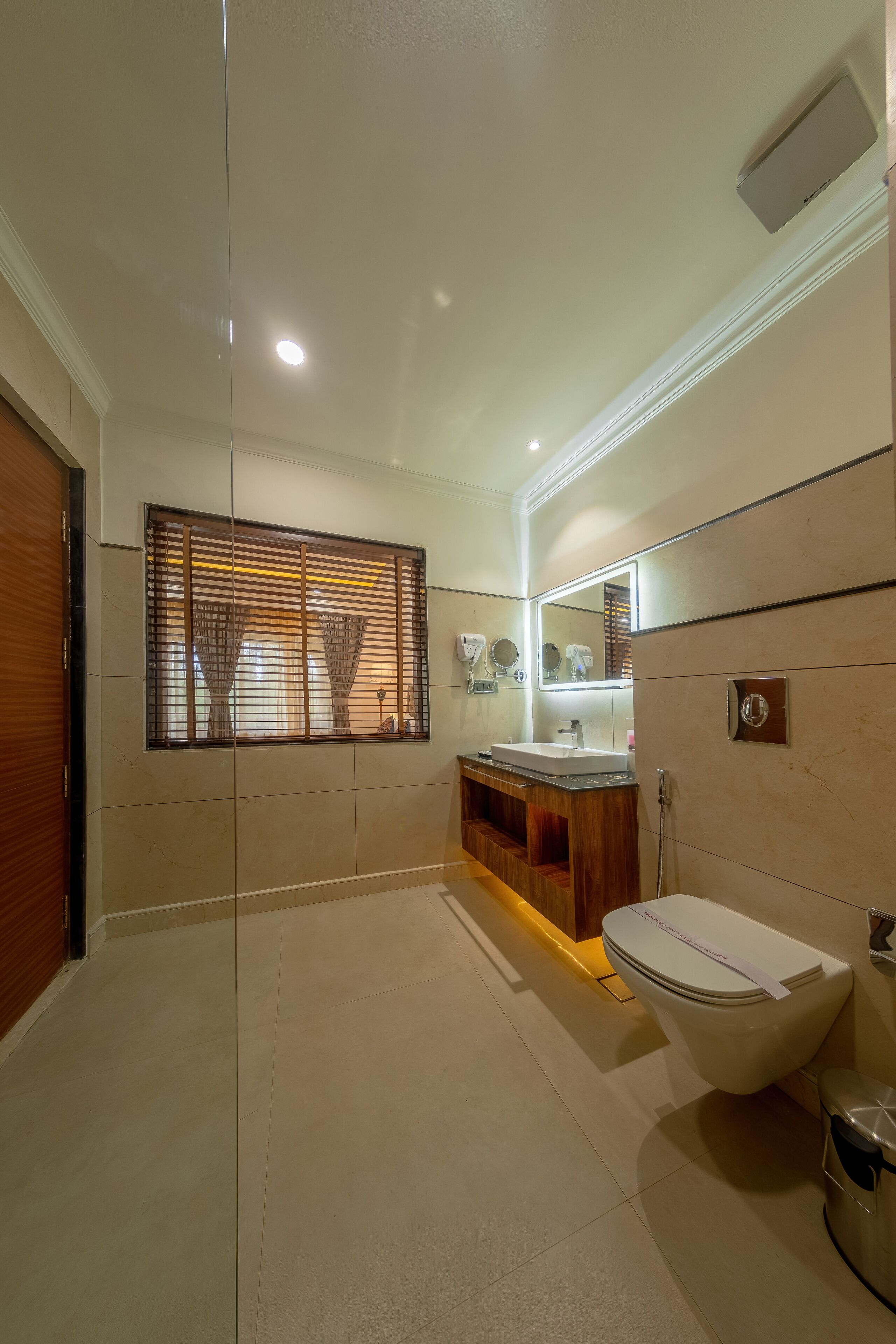 A modern bathroom with a toilet, sink, and vanity.
