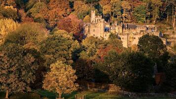 A historic stone building surrounded by autumn foliage.
