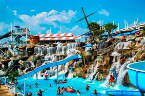 Enjoy water activities and relax in the pool area with umbrellas and seating.
