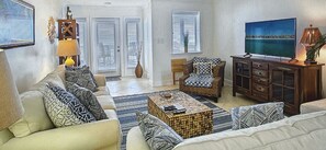Relax in the living room with a sofa, chair, and mounted TV.