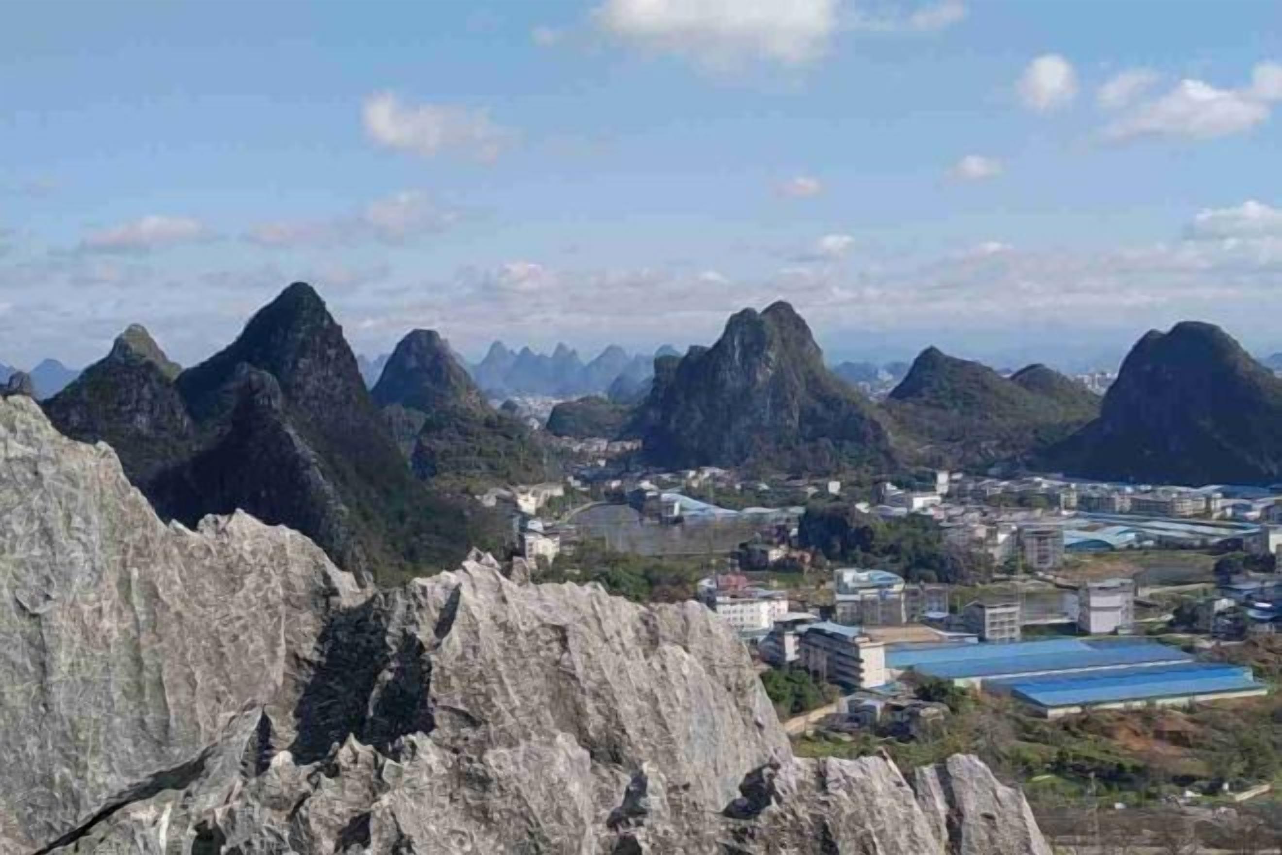A mountainous landscape with rocky terrain and a town in the valley below.