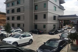 A multi-story parking garage with several cars parked. - Hongdou Mountain Villa (Pingyuan)