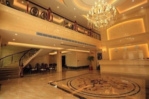 A grand lobby with a marble floor, a staircase, and a chandelier. - Hongdou Mountain Villa (Pingyuan)