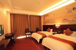 A hotel room with two beds, a desk, a chair, and a large window with curtains. - Hongdou Mountain Villa (Pingyuan)