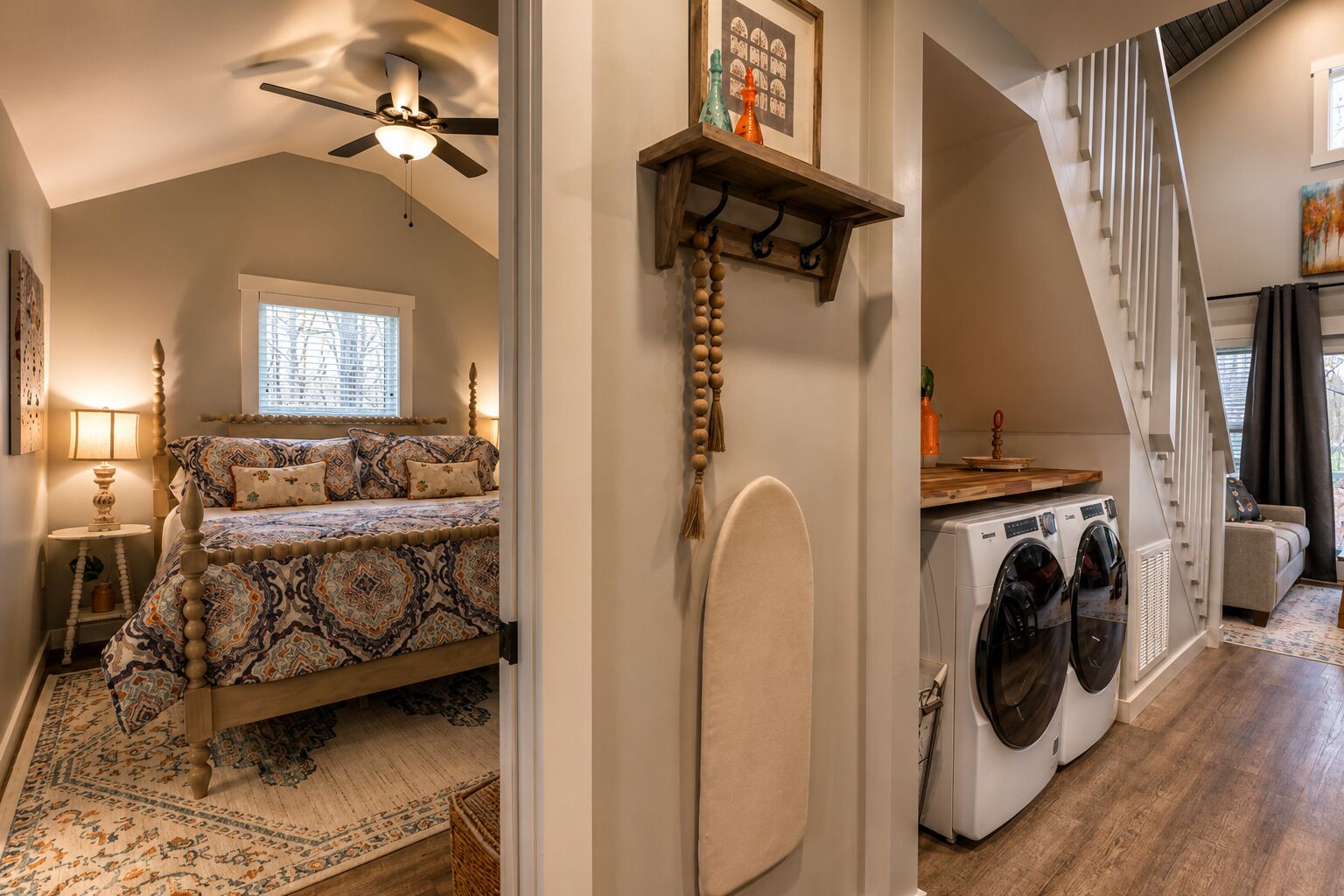 A bedroom with a bed, a ceiling fan, a window, and a nightstand.