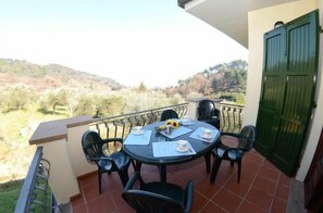Dine al fresco with a view of the surrounding hills from this outdoor dining area.