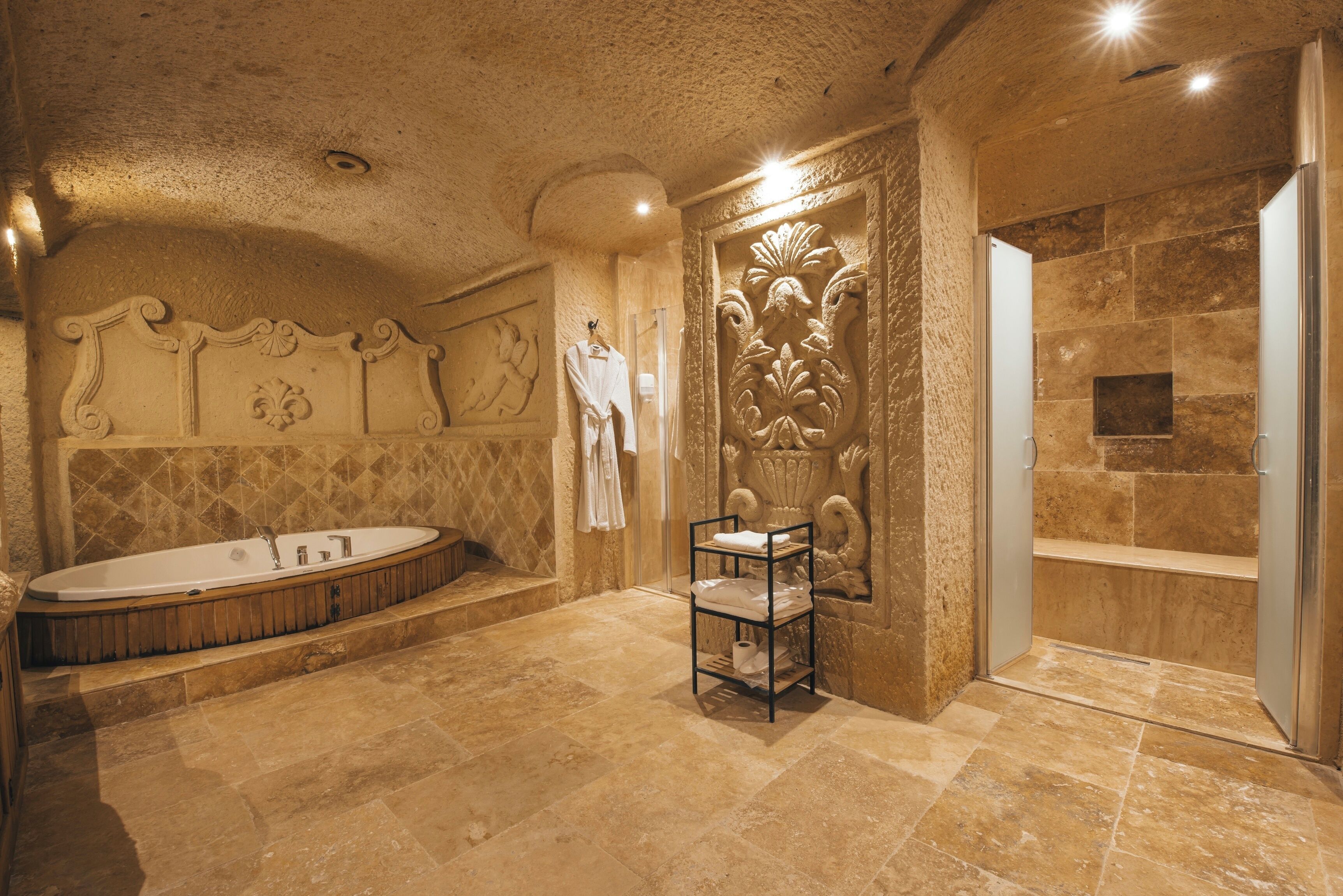 A spacious bathroom with a freestanding bathtub, a shower area, and a vanity with a towel rack.