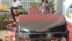 A stainless steel barbecue grill with a shiny, reflective surface, placed on a table with a red tablecloth. - Luxury all- inclusive villa w/ private chef (Puerto Plata)