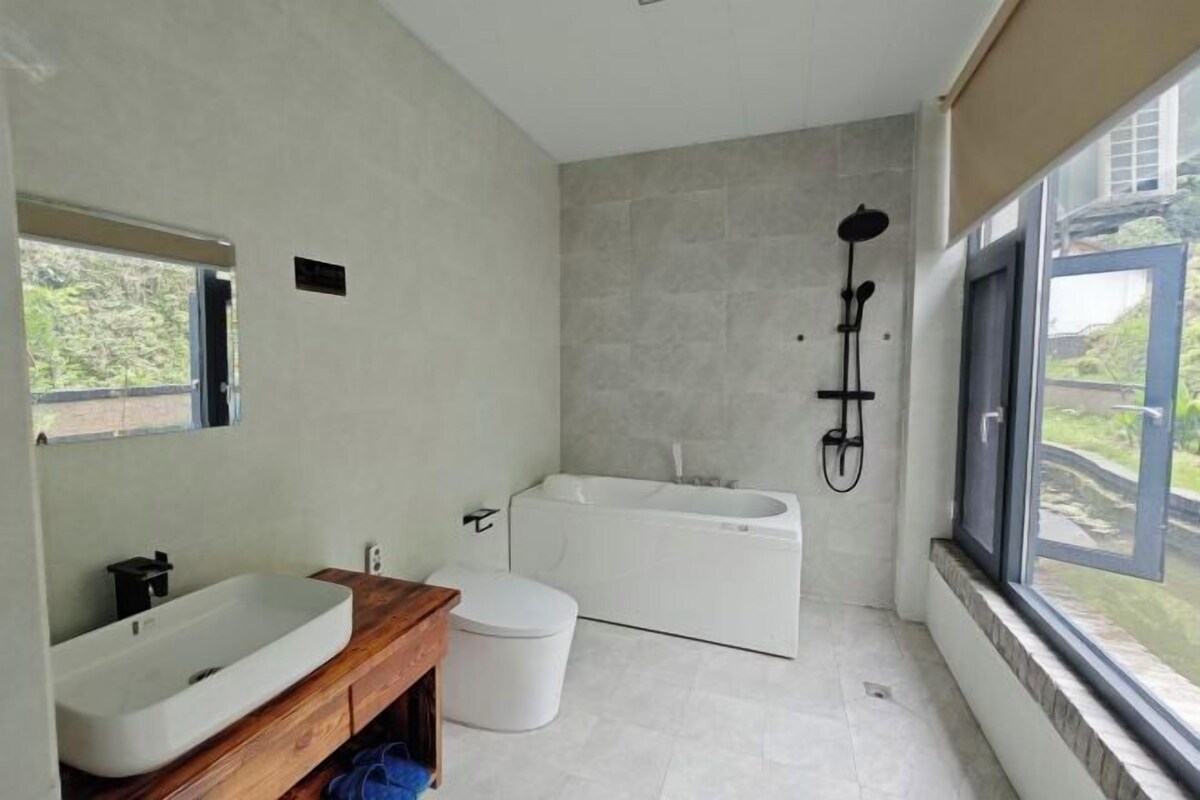 A modern bathroom with a bathtub, a sink, and a toilet.
