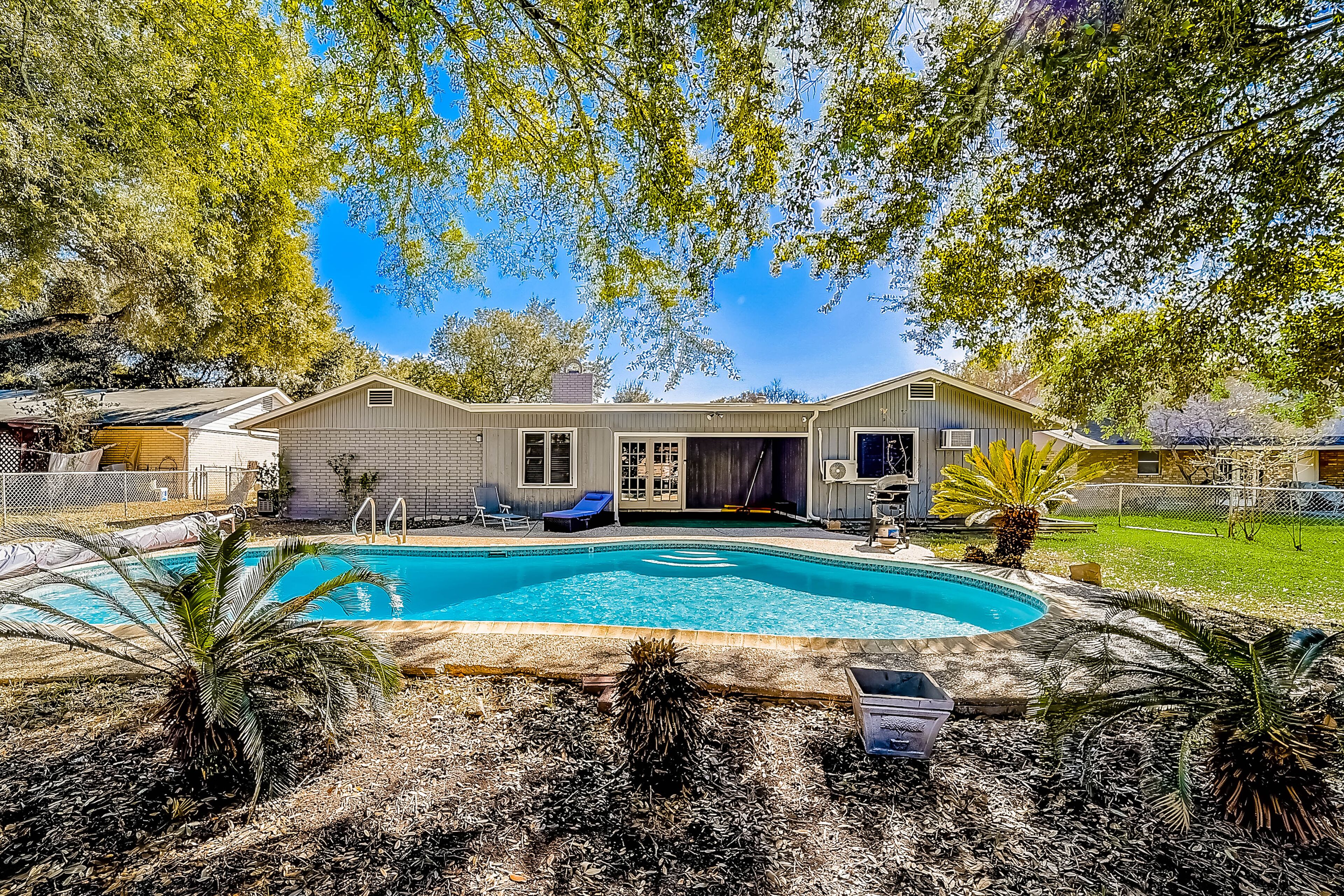 Inviting home with heated pool, enclosed yard, central AC, & W/D - dog-friendly