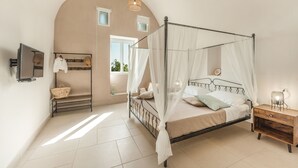A bedroom with a four-poster bed, a bedside table, a TV, a window, and a wall-mounted shelf. - Calacala rooms, restaurant & farm experience (Procida)
