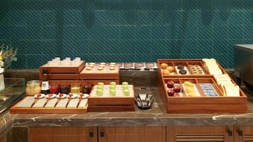 A breakfast buffet with various food items and condiments.