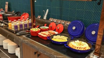 A buffet with various food items and beverages.