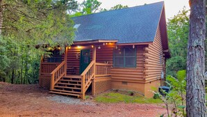 A log cabin with a porch, a staircase, and a window. - Labor Day at Pike's Peak - Wifi and Hot Tub! - Callaway Gardens (Warm Springs)