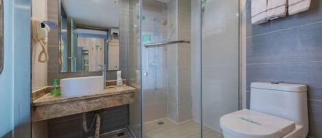 A modern bathroom with a glass-enclosed shower, a white sink, and a toilet.