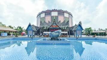 A large circular building with a central fountain, surrounded by a reflective pool.