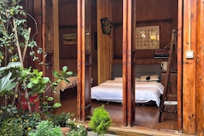 A wooden room with a bed, a ladder, and a small plant. - Lijiang Chenjie Inn (Sifang Street Branch) (Lijiang)