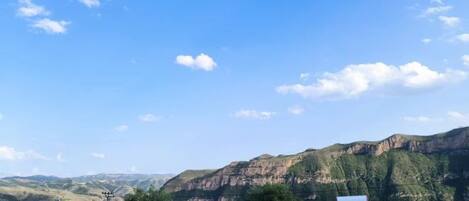 A view of a mountainous landscape with a clear sky.