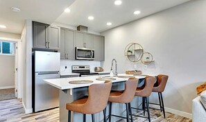 Fridge, stovetop, dishwasher, coffee/tea maker