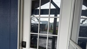 A white door with a window, a doorbell, and a mailbox. - Casa Luna Blue Ridge Parkway (Arden)