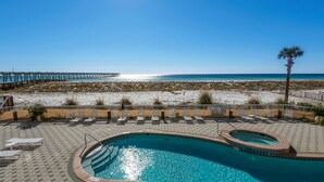 A pool area with a view of the beach and a pier. - ⭐Beachfront-Gulf Views-Pools and Hot Tubs-3BR Summerwind 1301⭐ (Navarre)