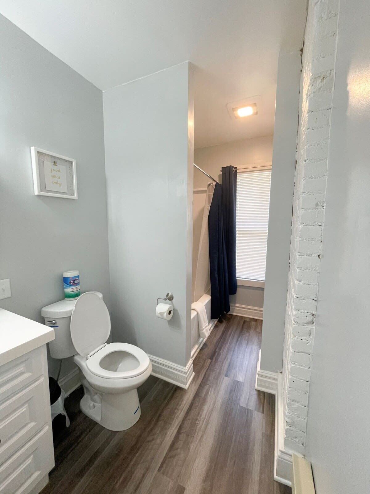 A bathroom with a toilet, a shower, and a bathtub.