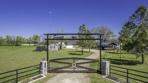 A gated entrance with a sign reading "Sweet Dove" and a star symbol. - SweetDove Stays-  Suite; w/ Stocked Lake, Secure Parking (Rains County)