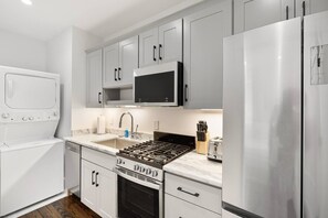 Fridge, microwave, coffee/tea maker, cookware/dishes/utensils