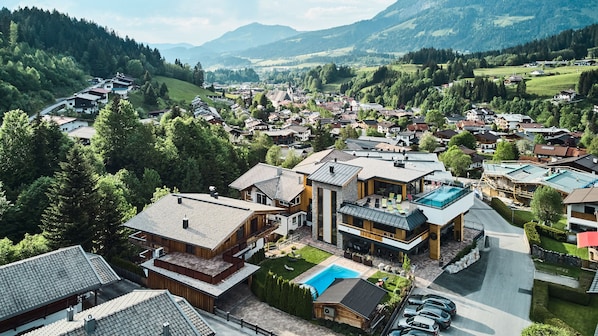 A residential area with modern houses, a swimming pool, and a church.