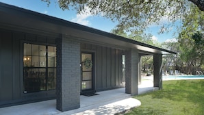 A modern building with large windows and a covered porch.