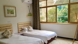 A room with two beds, a window with a view of greenery, a wooden headboard, and a small shelf with a plant. - Nanxi Longevity Flower Farmer Stay Inn (Yongjia)