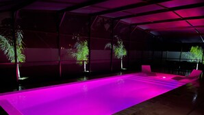 A swimming pool with a long, narrow shape and a flat, sloped edge. - The Ultimate Escape (Palm Coast)