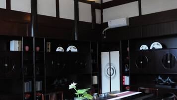 A traditional Japanese-style room with tatami flooring, a low table, and a shoji screen.