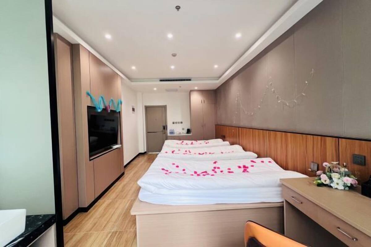 Une chambre d’hôtel avec un lit, un bureau et une kitchenette.