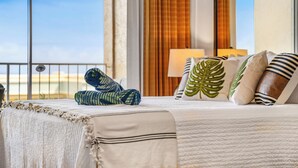 A hotel room with a bed, a view of the sea, and a window with curtains. - Ocean Tropics Oasis, Beachfront, King bed, AC/pool (Lahaina)