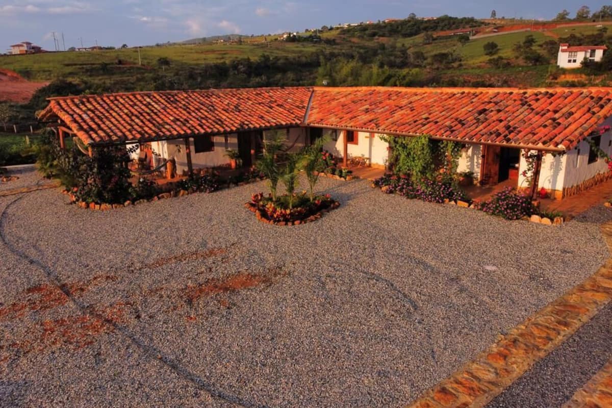 A building with a tiled roof and a gravel courtyard.