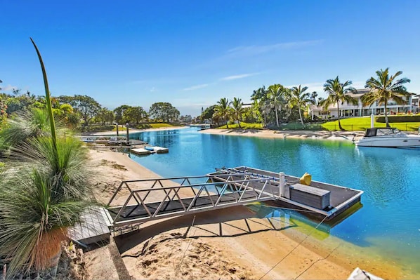Enjoy waterfront views and access to a dock area with boats moored nearby.