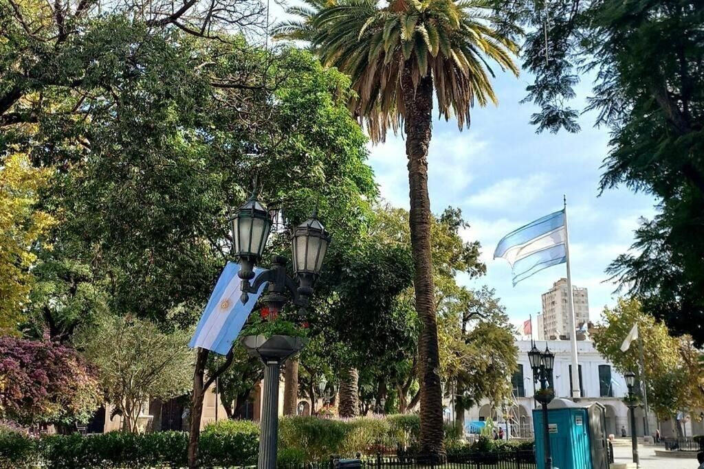 Ein Park mit Bäumen, einer Straßenlaterne und einer Flagge.