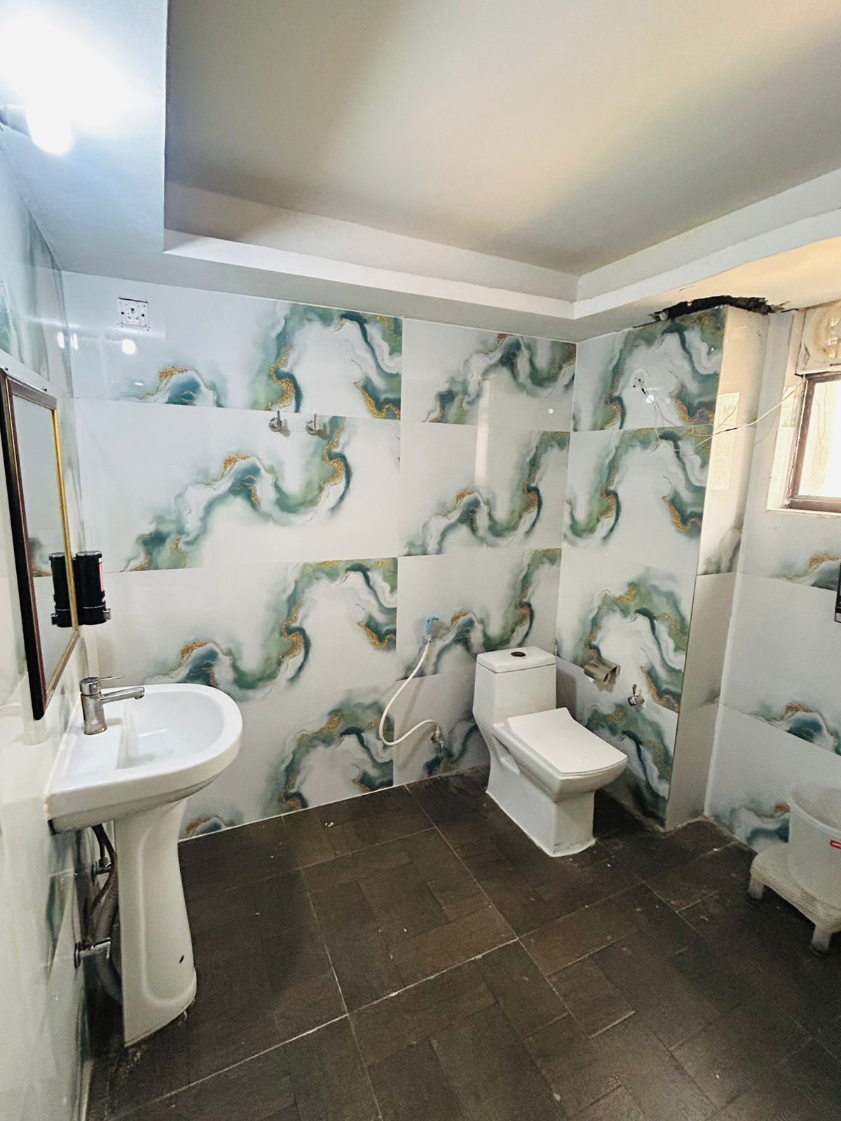 A bathroom with a sink, toilet, and shower.