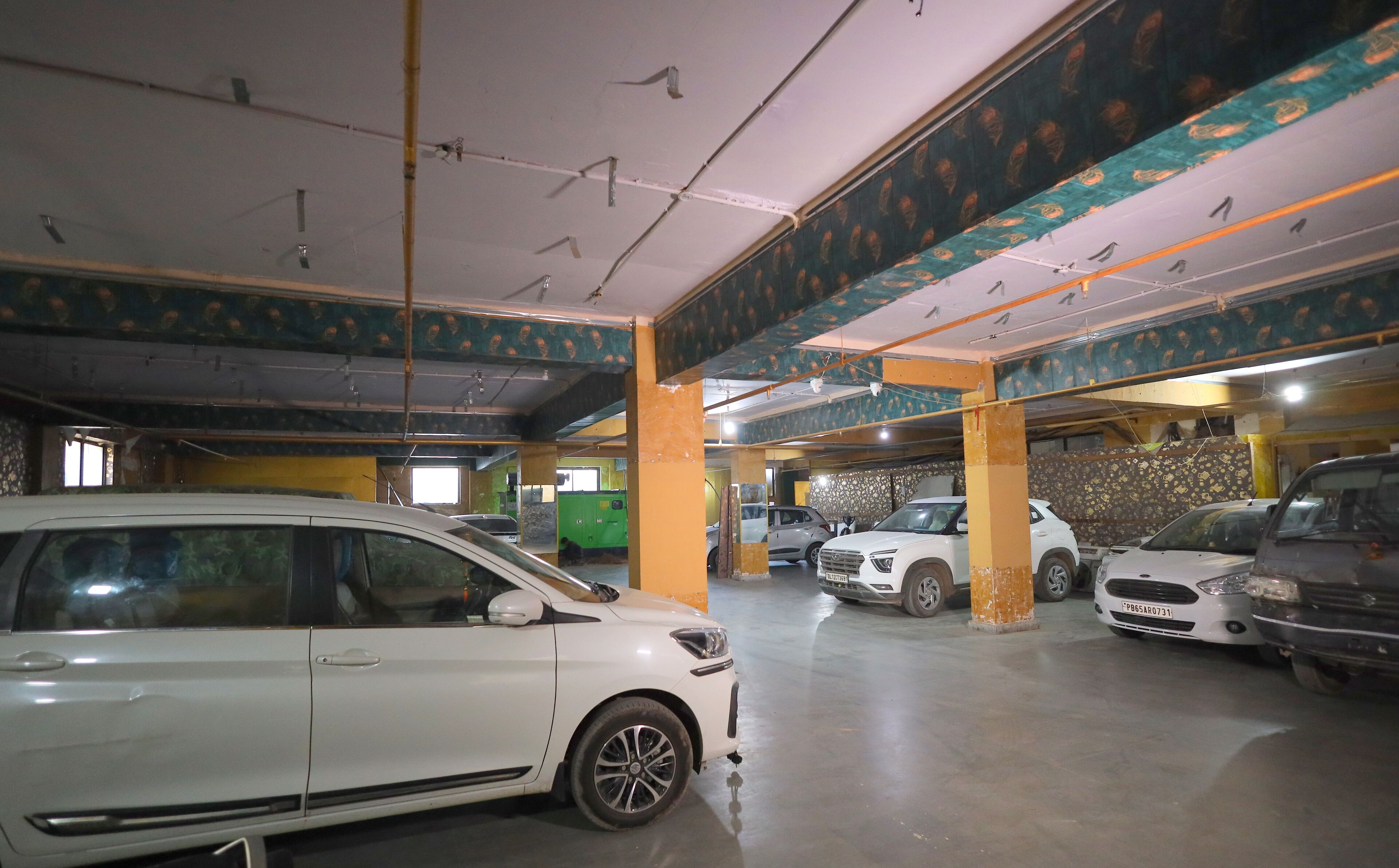 A multi-level parking garage with several cars parked.