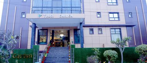 A building with a sign reading "Tulsi Garden" at the entrance.