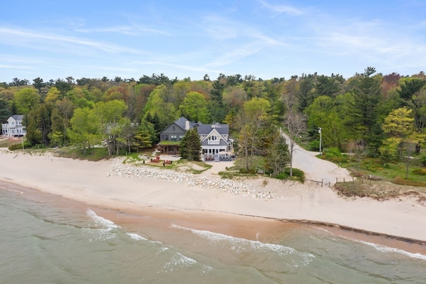 Aerial view showing the home’s private beachfront setting.