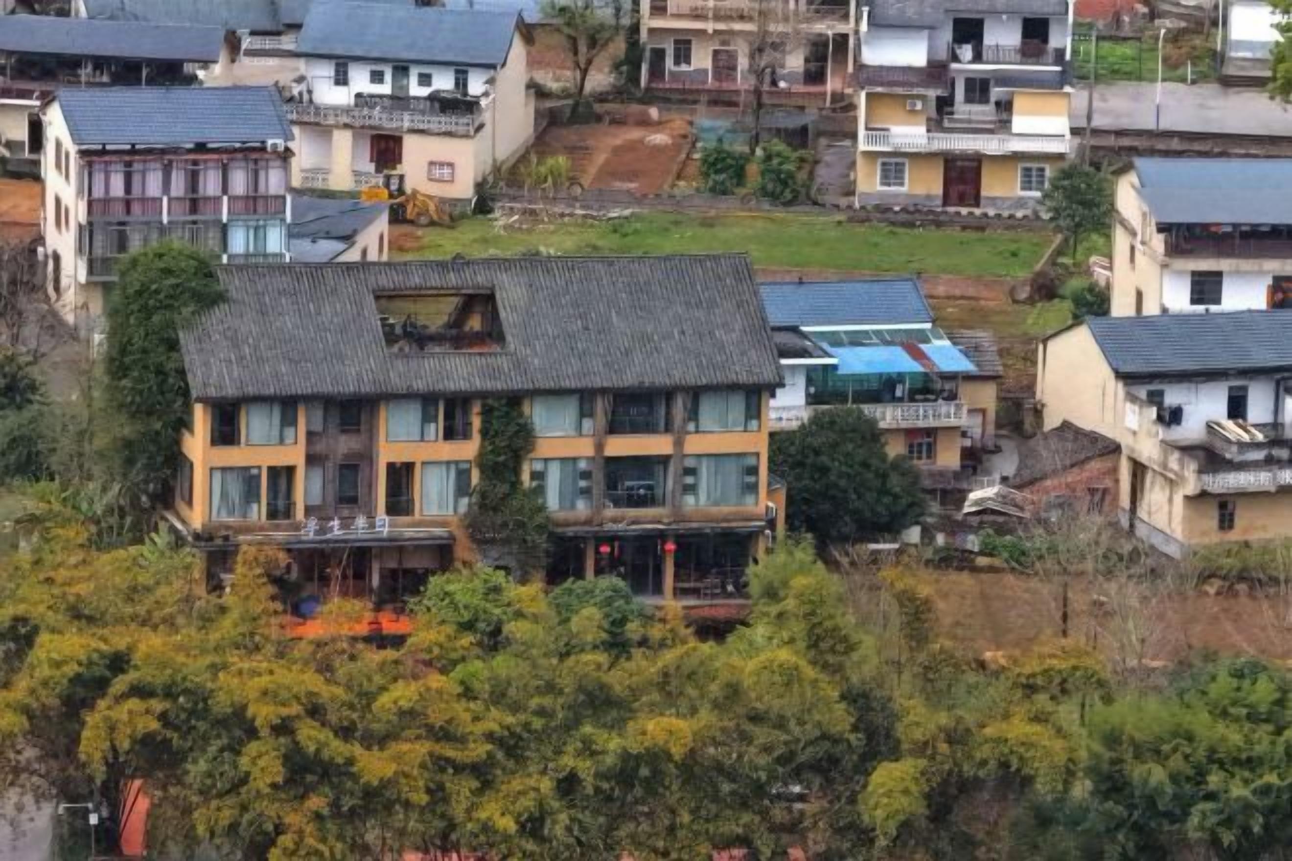 A residential area with multiple houses, including a two-story building with a balcony.