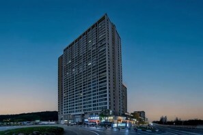 A high-rise building with a grid of windows, a flat roof, and a wide base. - HAI FU JING (Guiyang)