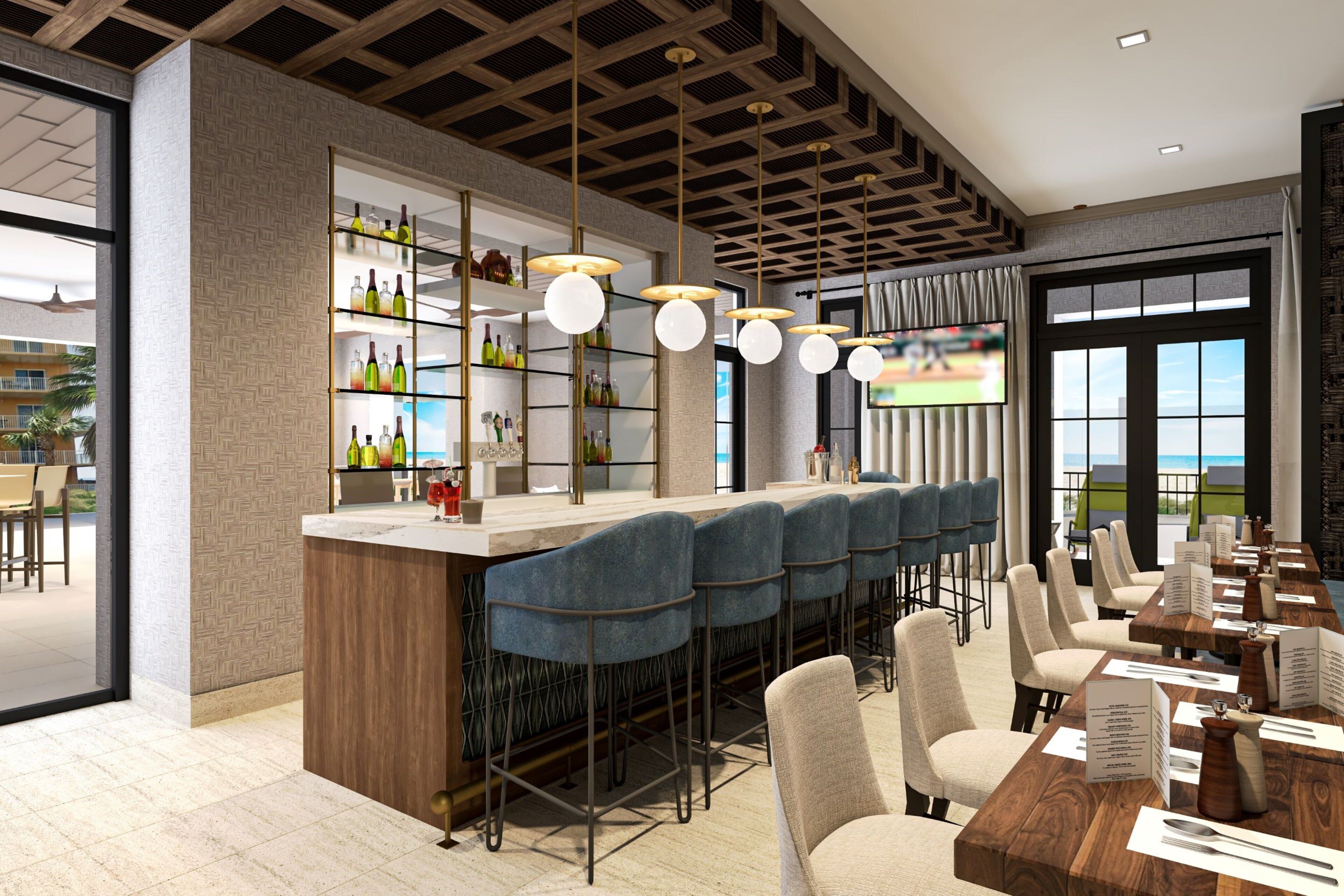 A modern bar area with a long counter, multiple bar stools, and a television screen.