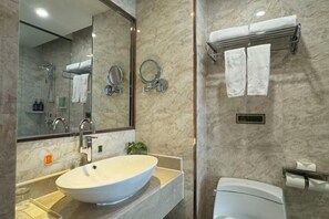 A modern bathroom with a large oval sink, a mirror, a toilet, and a towel rack. - Vienna Hotel (Dongtai Chengdong New District) (Dongtai)